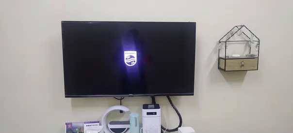 Philips 40-inch LED TV mounted on wall - good working condition