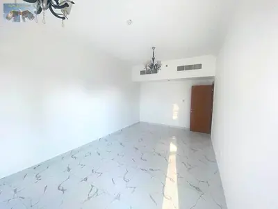 Annual rental apartment in Al Nakheel with two bedrooms, living room, two balconies, three bathrooms and private parking near Lulu Market.