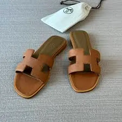 Mastercopy of Hermès Oran sandals in brown calfskin, featuring the iconic H-shaped cutout on the top