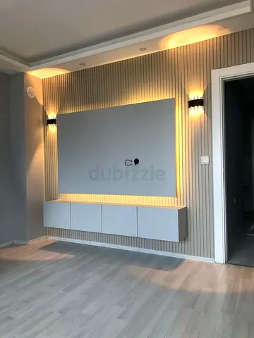 Modern wall-mounted TV unit with LED backlight and storage cabinets