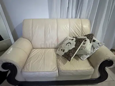 Cream leather 2-seater sofa with wooden trim — good condition
