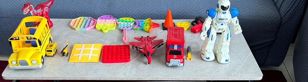 Mixed kids toys bundle — robot, vehicles, pop-its, plane, school bus