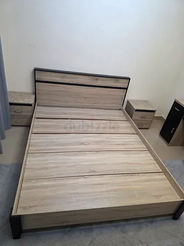Queen size wooden bed frame with headboard and bedside tables