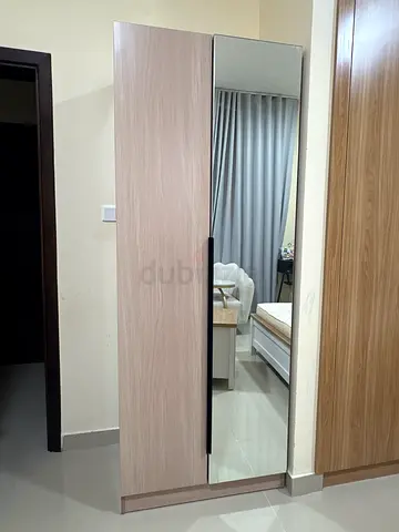 IKEA PAX-style sliding door wardrobe with full-length mirror