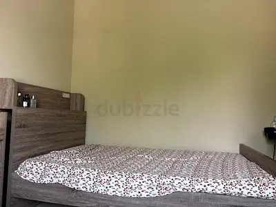 wooden bed with an integrated storage headboard