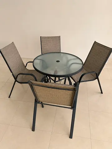 Outdoor glass-top table with 4 sling chairs - good condition