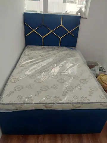 Blue upholstered double bed with mattress - good condition