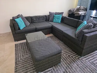 Sofa set with glass top coffee table, foot rest and throw pillows