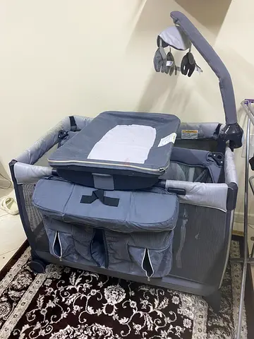 Used grey baby playpen / playard with changing station and storage