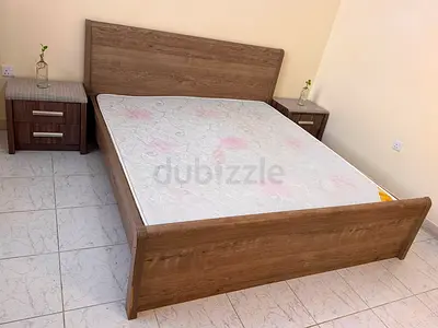 Queen-size wooden bed frame with mattress and bedside tables - good condition