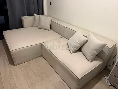 Light beige L-shaped modular sofa with chaise, good condition