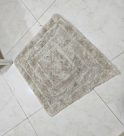 Beige square shaggy bathroom rug / small accent carpet - gently used
