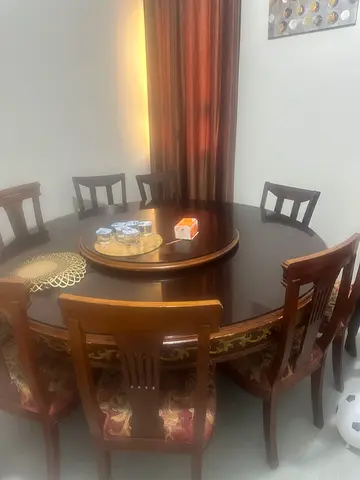 Wooden round dining table with 6 upholstered chairs - good condition