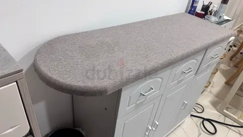Ironing table with storage - movable with wheels.