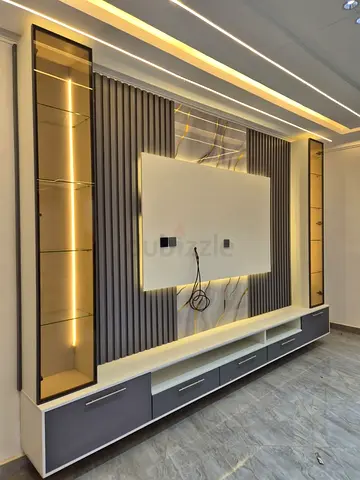 Modern wall-mounted TV entertainment unit with built-in LED display shelves
