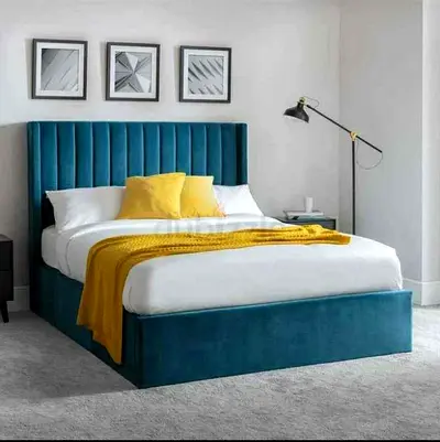 King-sized teal upholstered platform bed with tall channel-tufted headboard