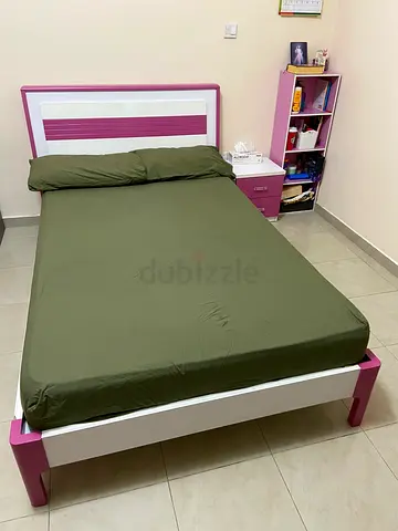 Double bed with mattress and side table