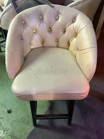 Cream tufted accent chair with dark wooden legs
