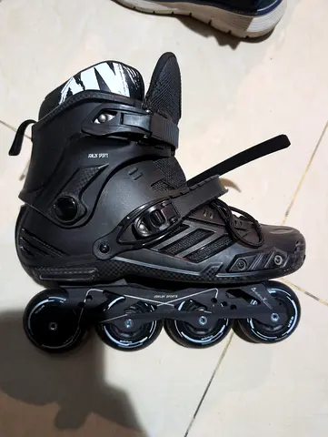 Pair of used black inline rollerblades, size adjustable