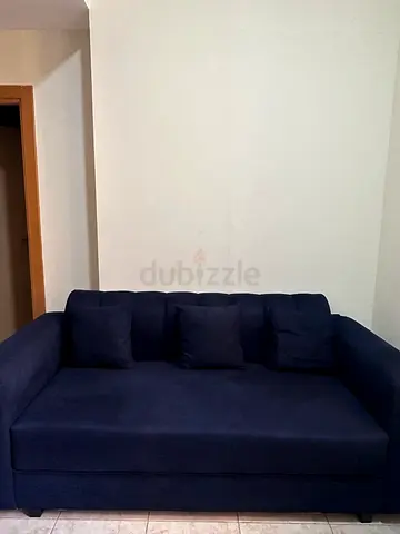 Compact navy blue 3-seater sofa with cushions