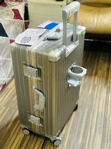 24” (25kg)Silver hard-shell carry-on suitcase with wheels and cup holder