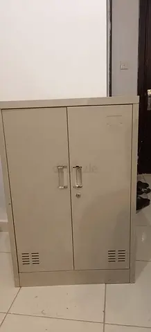 Used metal storage cabinet with lockable doors - compact..shoe rack