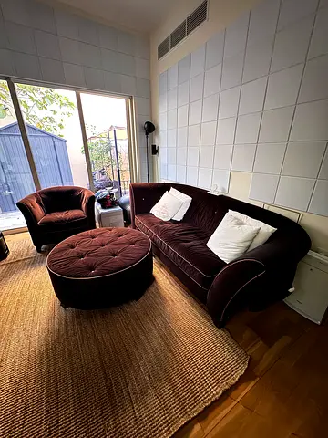 Curved brown velvet sofa set with matching ottoman and armchair