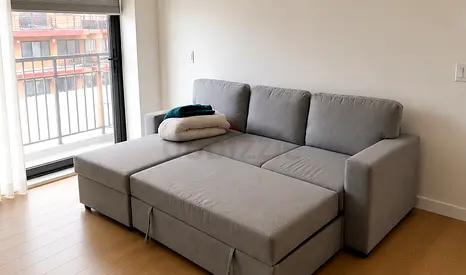 Grey L-shaped Sofa Bed with Storage - Good Condition