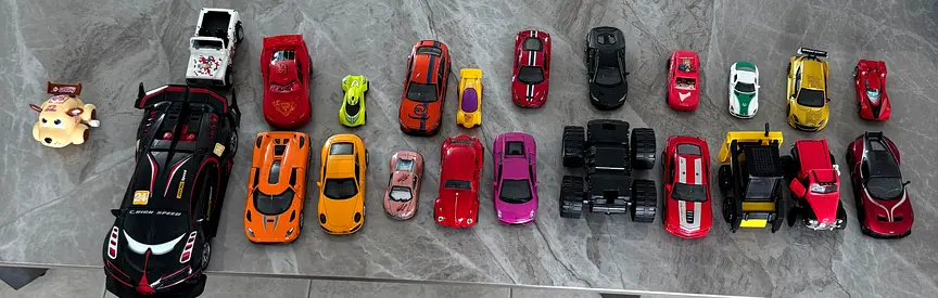 Lot of 24 toy cars and 1 toy truck - mixed diecast and plastic models