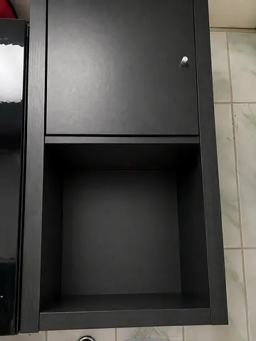 Black compact cabinet with open shelf and  door