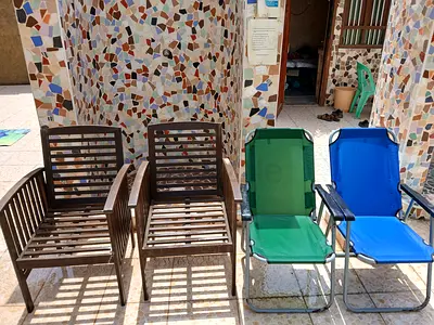 Set of 4 outdoor chairs — 2 wooden slat chairs + 2 folding loungers