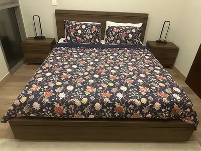 King Size ottoman bed (storage), mattress, two bed side tables, chest of drawers with vanity mirror.