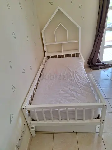 Etsy white house-frame kid bed with bookshelf headboard, good condition