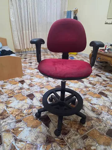 Red swivel office chair with armrests — good condition