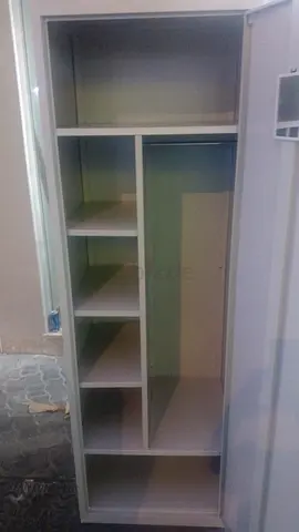 Tall metal wardrobe with shelves and hanging space