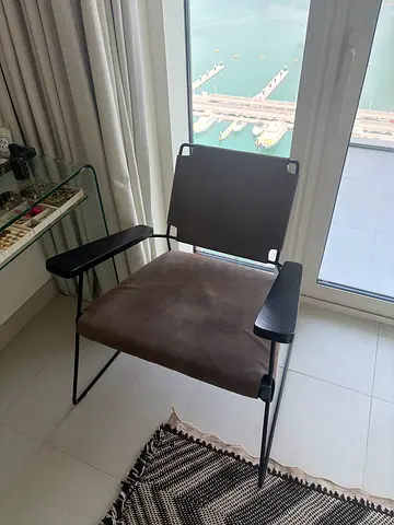 Modern metal frame lounge chair with suede seat and armrests