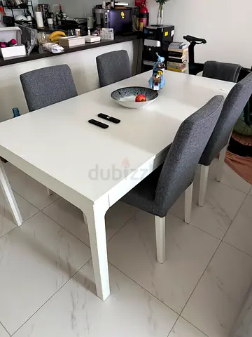 White dining table with 4 grey upholstered chairs - good condition
