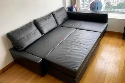 Black leather L-shape sofa bed - convertible, good condition