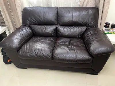 Dark brown 2-seater genuine leather sofa in good condition