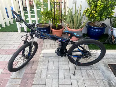 Pre-owned black  blue full-suspension mountain bike - good working condition