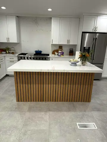 Modern kitchen island with marble top and slatted wood base
