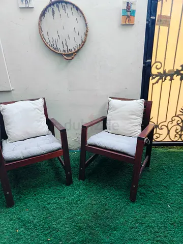 Pair of wooden outdoor armchairs with cushions
