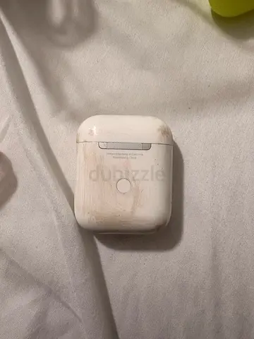 Used white wireless Bluetooth earbuds with charging case (wear visible)