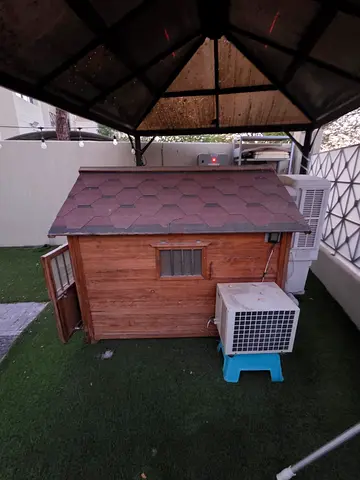 Wooden dog/cat house with Shingled Roof — excellent Condition. With AC. Original price 6000aed plus