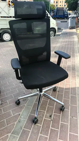 Used black office swivel chair with adjustable height and chrome base