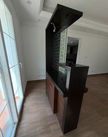 standing wooden room divider with storage and glass panel