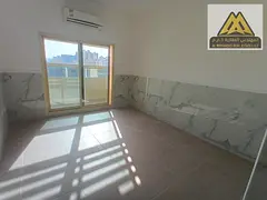 A spacious one-bedroom apartment with a balcony and open views in Al Rawda 2 area, close to all serv