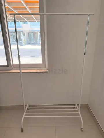 White metal freestanding clothes rack with wheels - adjustable height