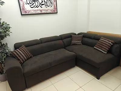 Dark brown L-shaped fabric sofa with ottoman, seats 4-5