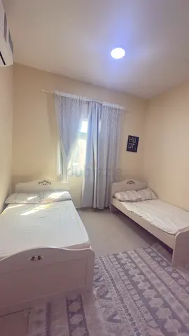 Two single white wooden beds with mattresses — good condition